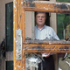 US ambassador to China James Sasser peers through the damaged door of the US embassy in Beijing.